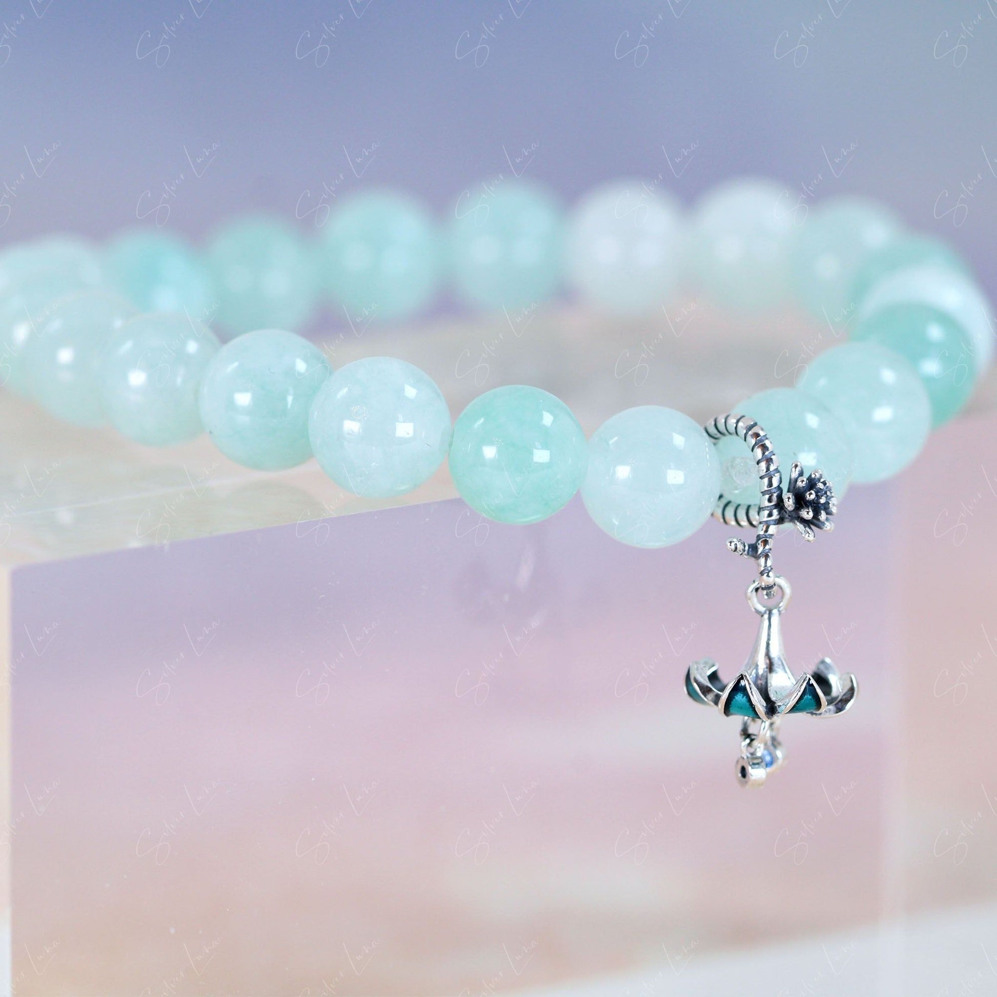 green beaded bracelet with bell flower charm