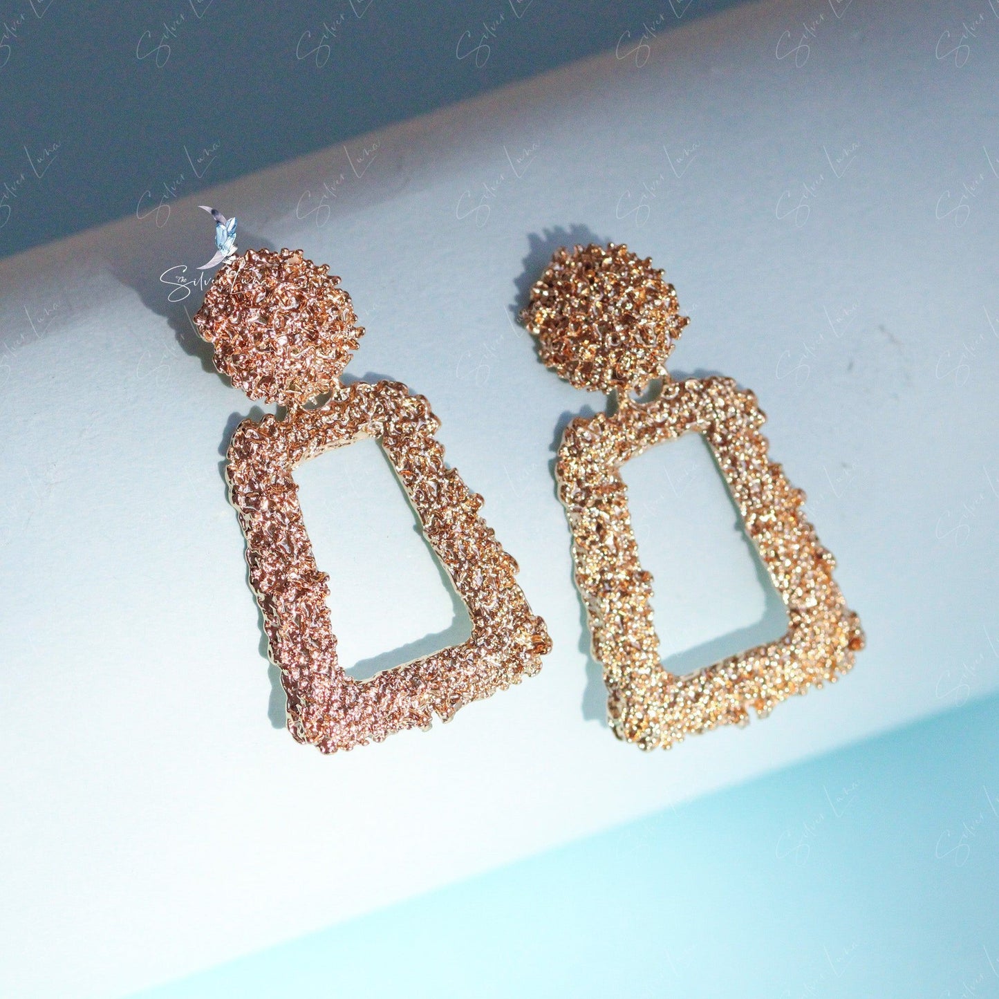 Golden textured metal statement earrings