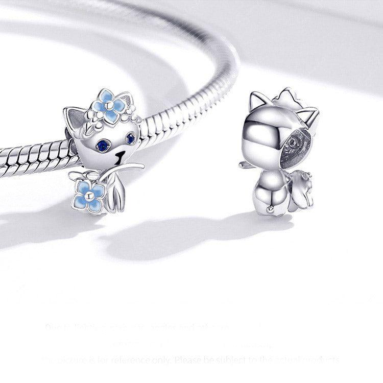 Cat holding blue flower sterling silver charm