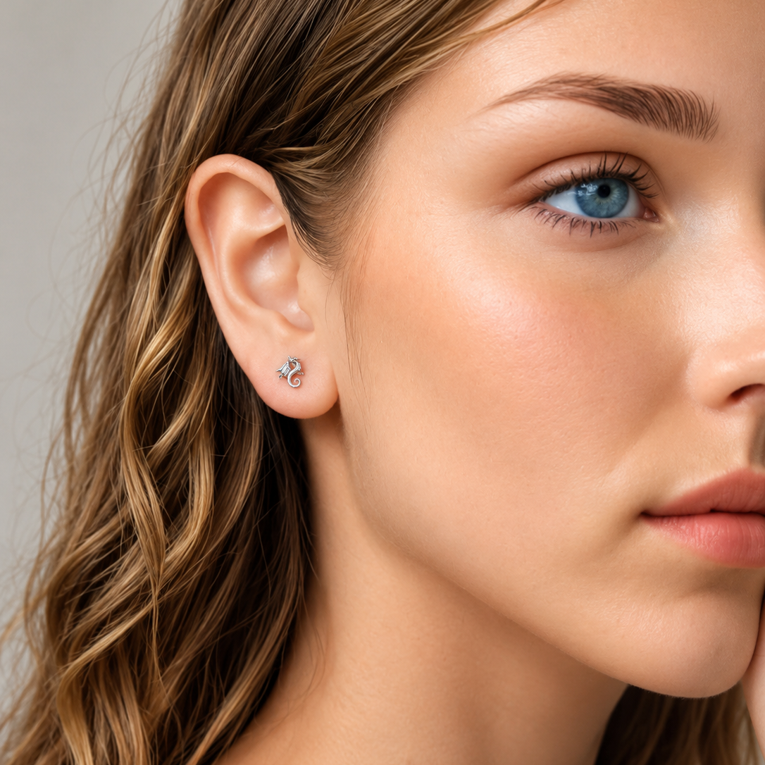 Close-up of a woman wearing a silver earring with a small gemstone.