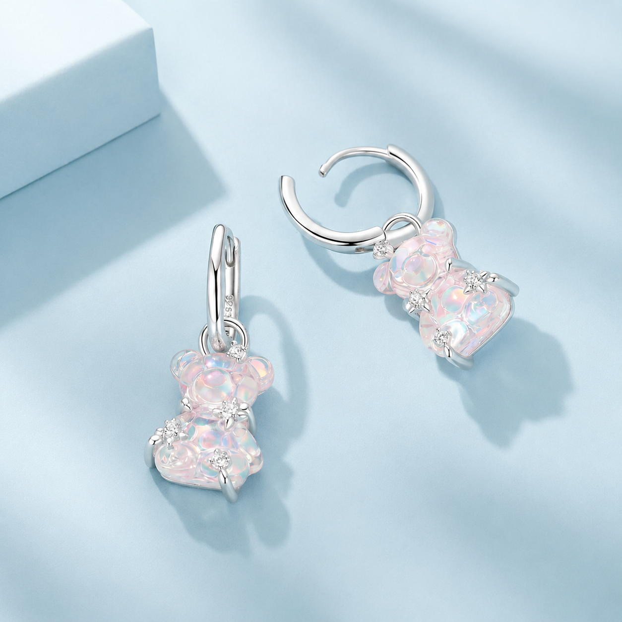 Pair of heart-shaped earrings on a light blue background