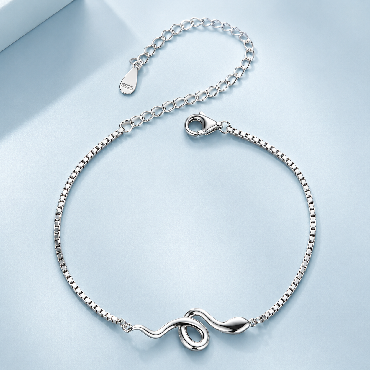 Silver bracelet with a subtle design on a light blue background