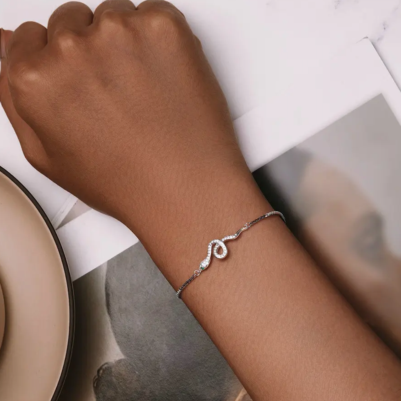 Silver bracelet on a wrist with a blurred background