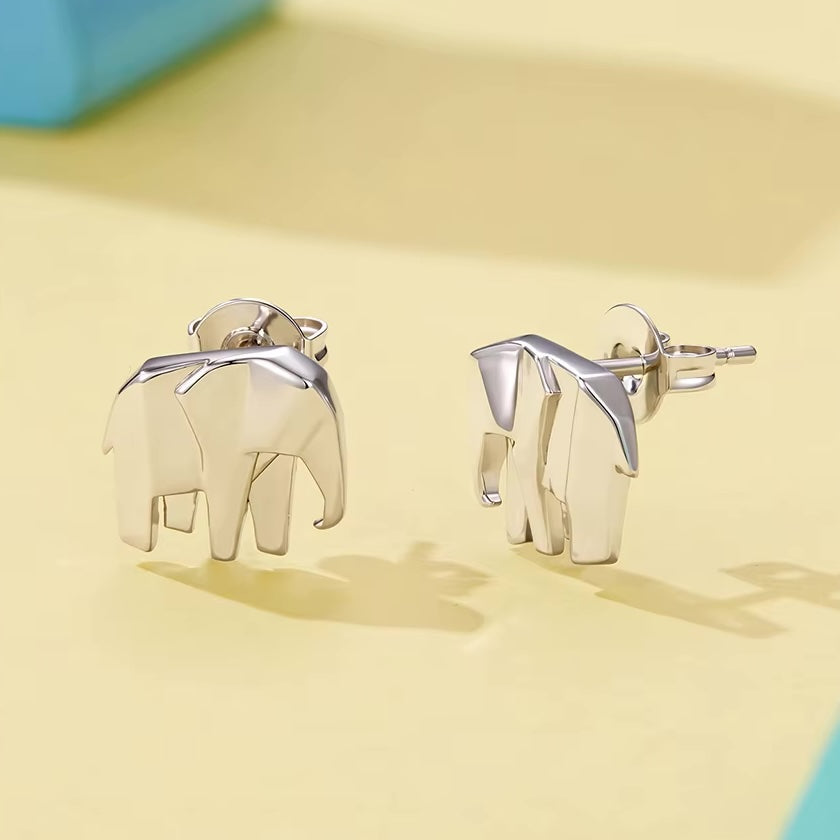 Silver elephant earrings on a yellow background