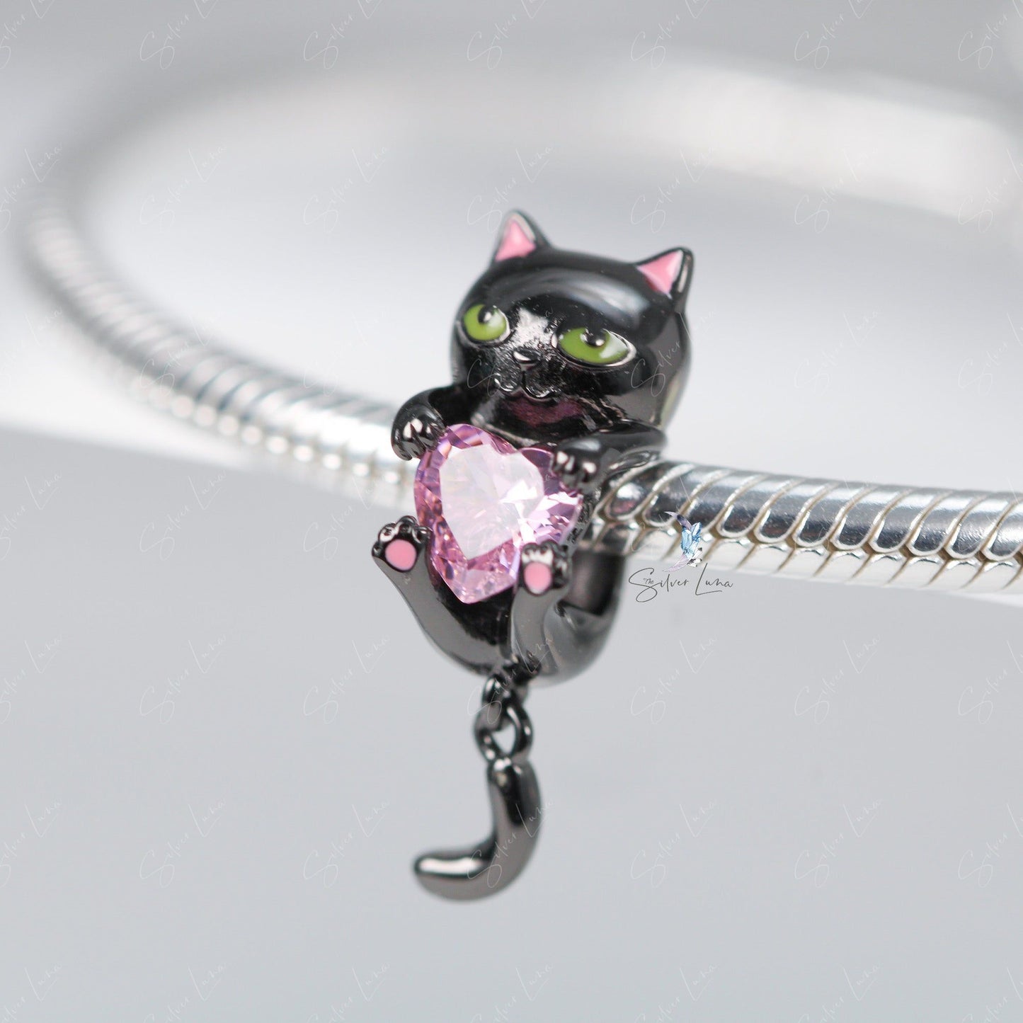 black cat holding heart charm