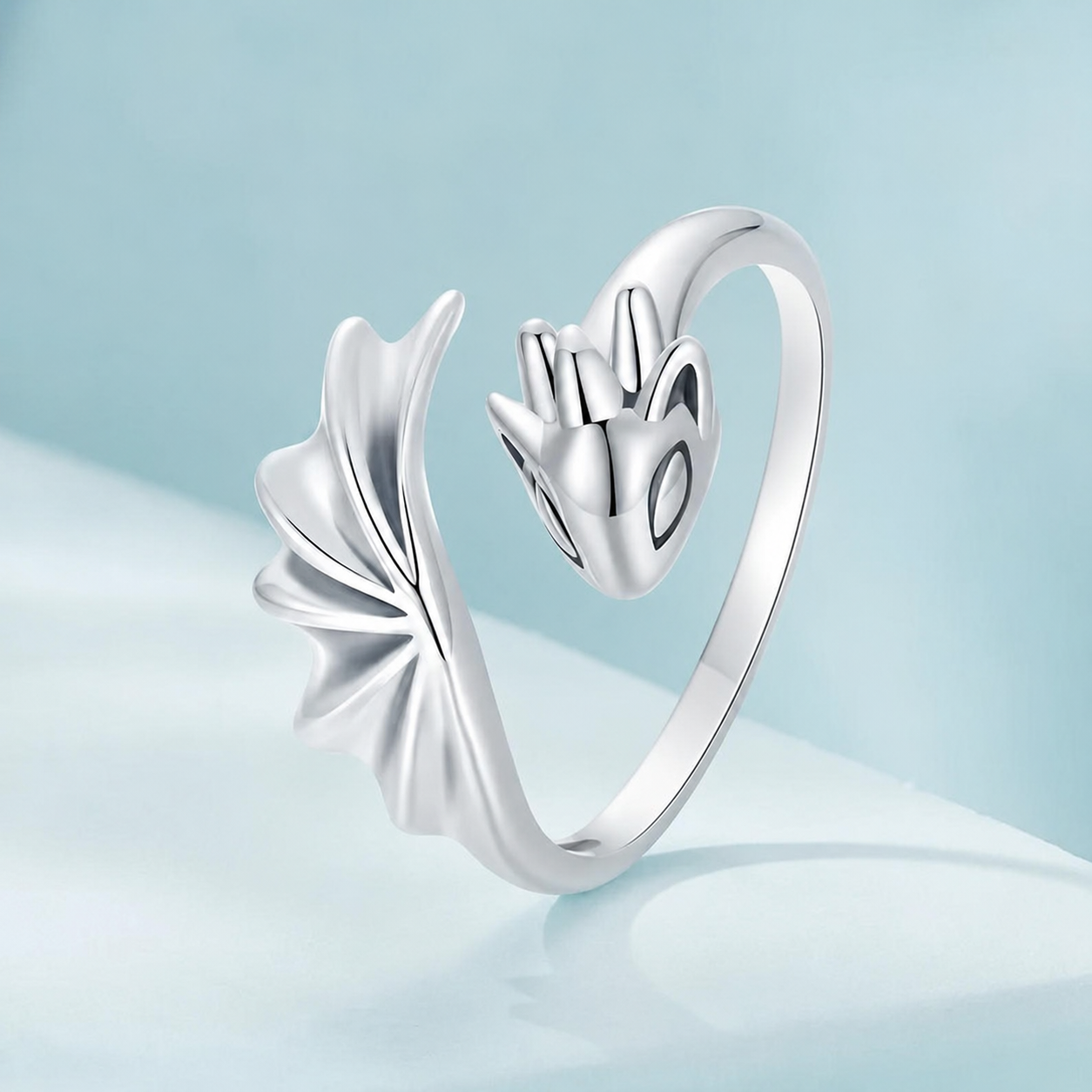 Silver ring with a unique design on a light blue background