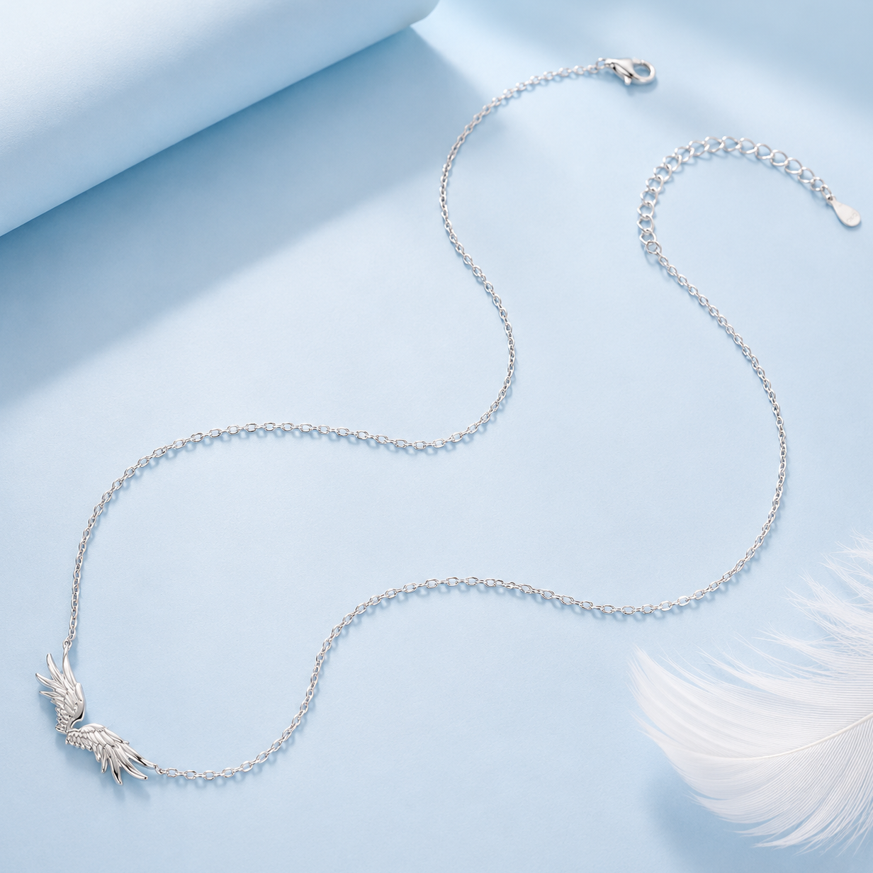 Silver necklace with a decorative clasp on a light blue background