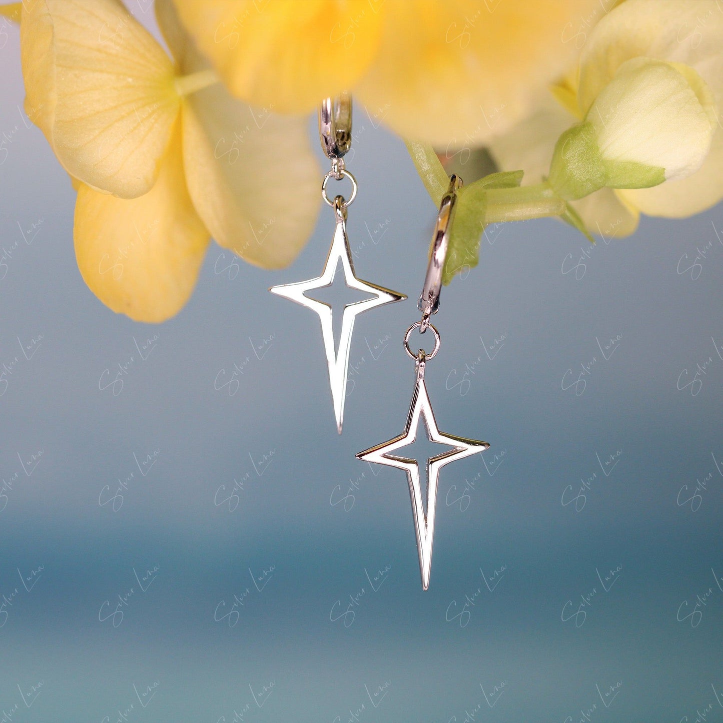 Pointed star cross hoop earrings
